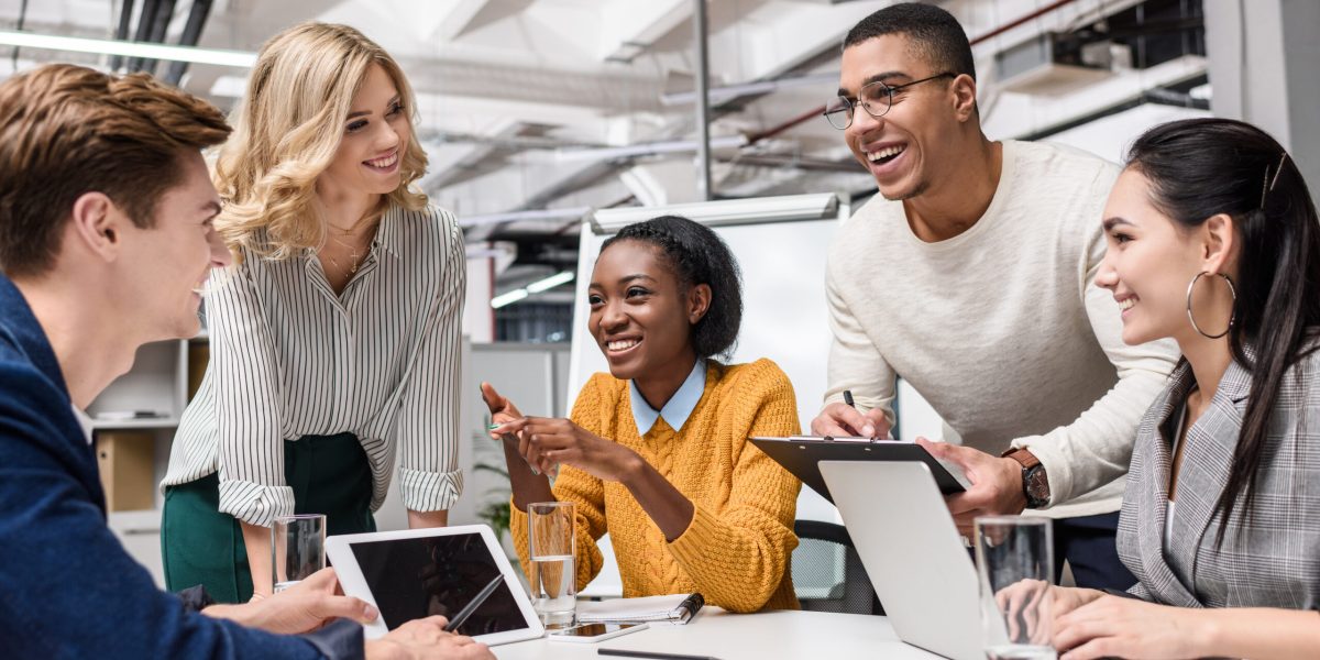 young happy managers working together at conference hall in modern office